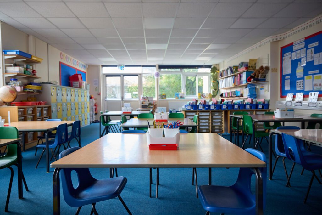 Empty Tables And Chairs In Classroom representing a nursery